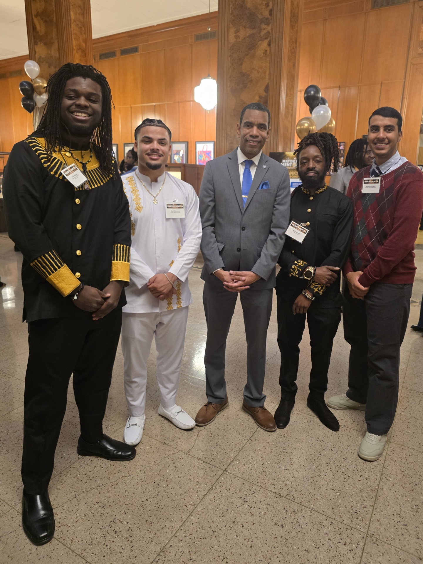 Mentor and his mentees pose with Rochester Mayor Malik Evans